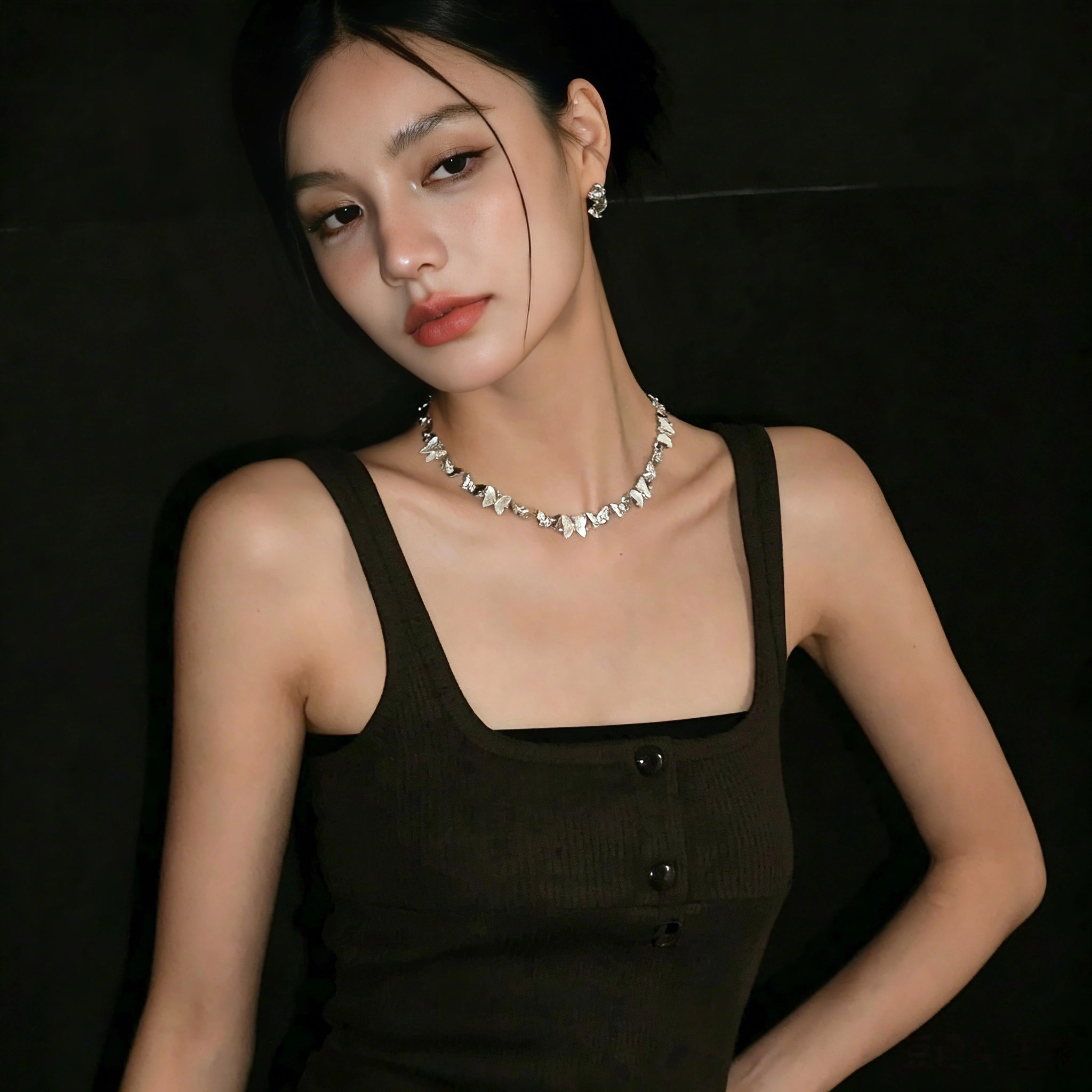 This delicate choker necklace features alternating polished metal butterflies and lustrous white mother-of-pearl butterflies, accented with tiny sparkling crystals. The shimmering white shell inlays contrast beautifully with the warm gold (or cool silver) metal finish, creating an elegant, whimsical design that sits close to the collarbone.