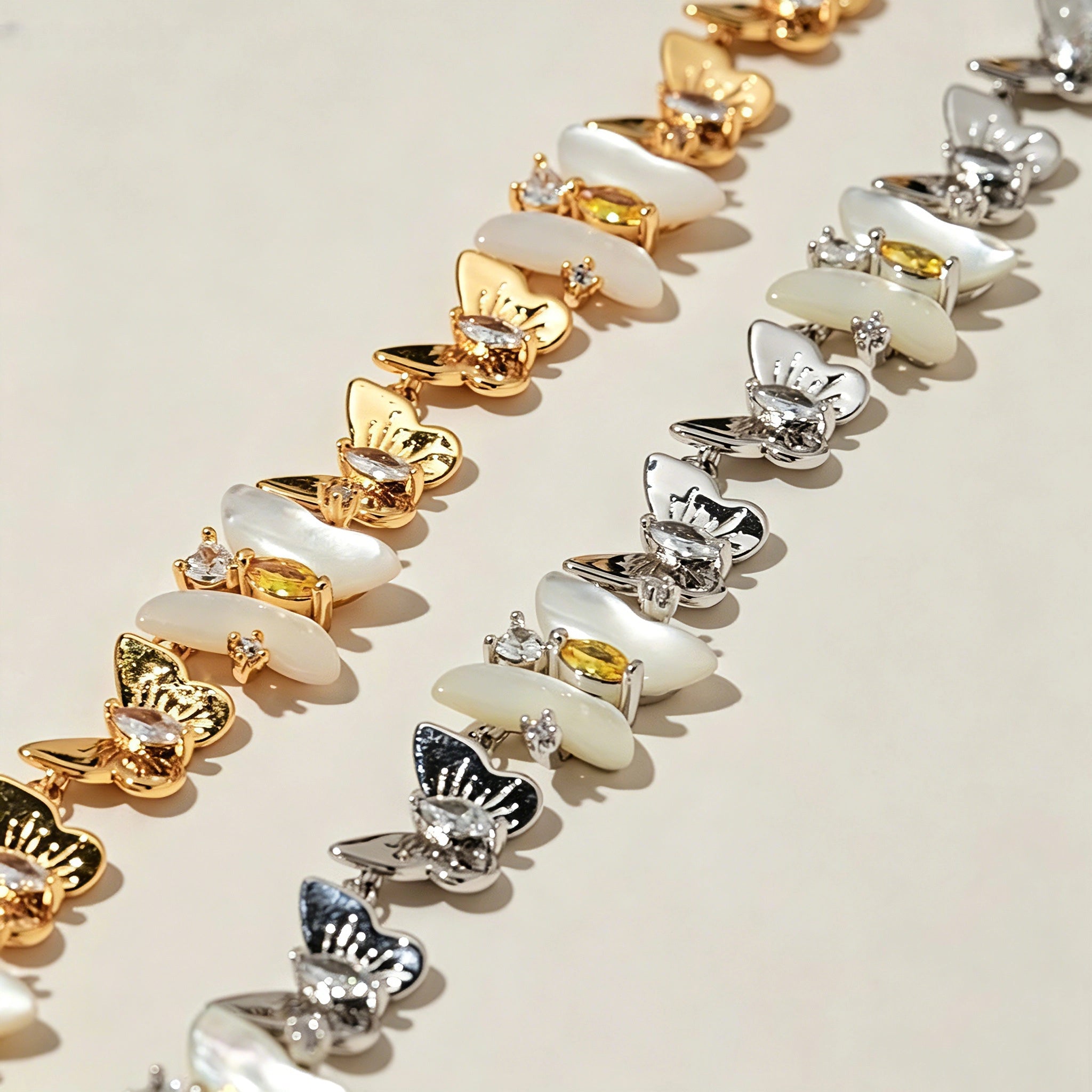 This delicate choker necklace features alternating polished metal butterflies and lustrous white mother-of-pearl butterflies, accented with tiny sparkling crystals. The shimmering white shell inlays contrast beautifully with the warm gold (or cool silver) metal finish, creating an elegant, whimsical design that sits close to the collarbone.