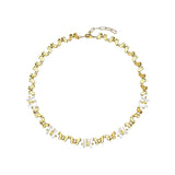 This delicate choker necklace features alternating polished metal butterflies and lustrous white mother-of-pearl butterflies, accented with tiny sparkling crystals. The shimmering white shell inlays contrast beautifully with the warm gold (or cool silver) metal finish, creating an elegant, whimsical design that sits close to the collarbone.