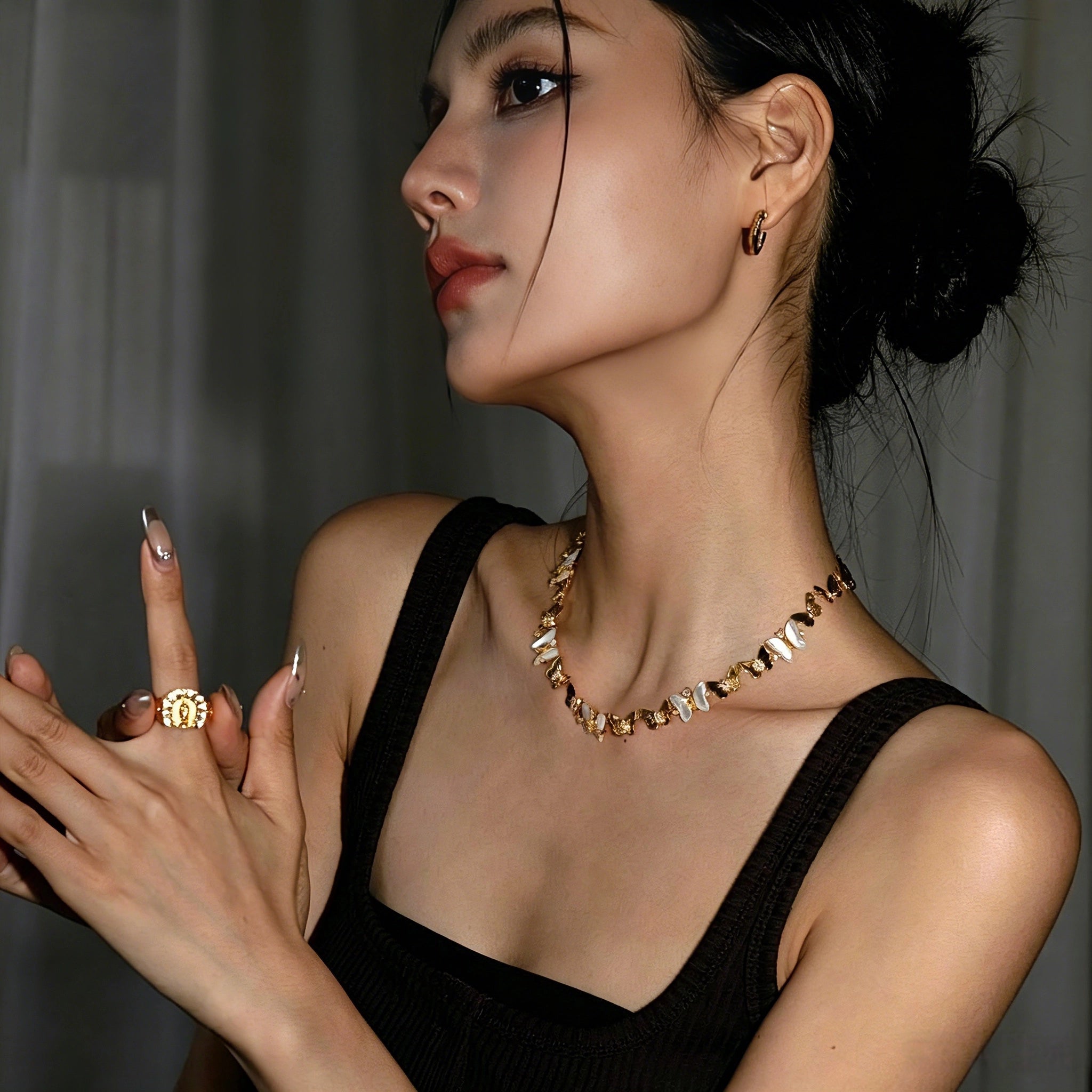 This delicate choker necklace features alternating polished metal butterflies and lustrous white mother-of-pearl butterflies, accented with tiny sparkling crystals. The shimmering white shell inlays contrast beautifully with the warm gold (or cool silver) metal finish, creating an elegant, whimsical design that sits close to the collarbone.