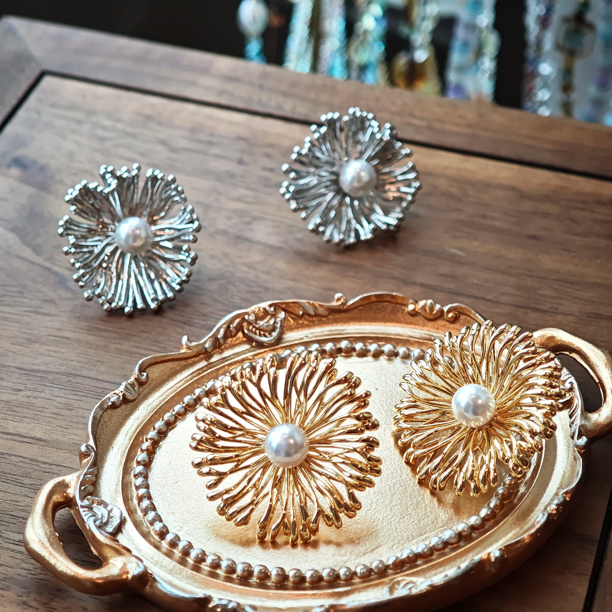 These earrings perfectly blend delicate flowers with lustrous pearls, exuding timeless romance and adding an elegant touch to any outfit.