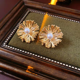 These earrings perfectly blend delicate flowers with lustrous pearls, exuding timeless romance and adding an elegant touch to any outfit.