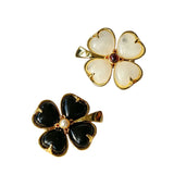 These four-leaf clover brooches come in two elegant versions: one with glossy black onyx petals centered by a delicate pearl, and the other with milky white crystal petals accented by a deep red gemstone at its core. Both are framed in polished gold-toned metal, exuding a classic, vintage-inspired charm.