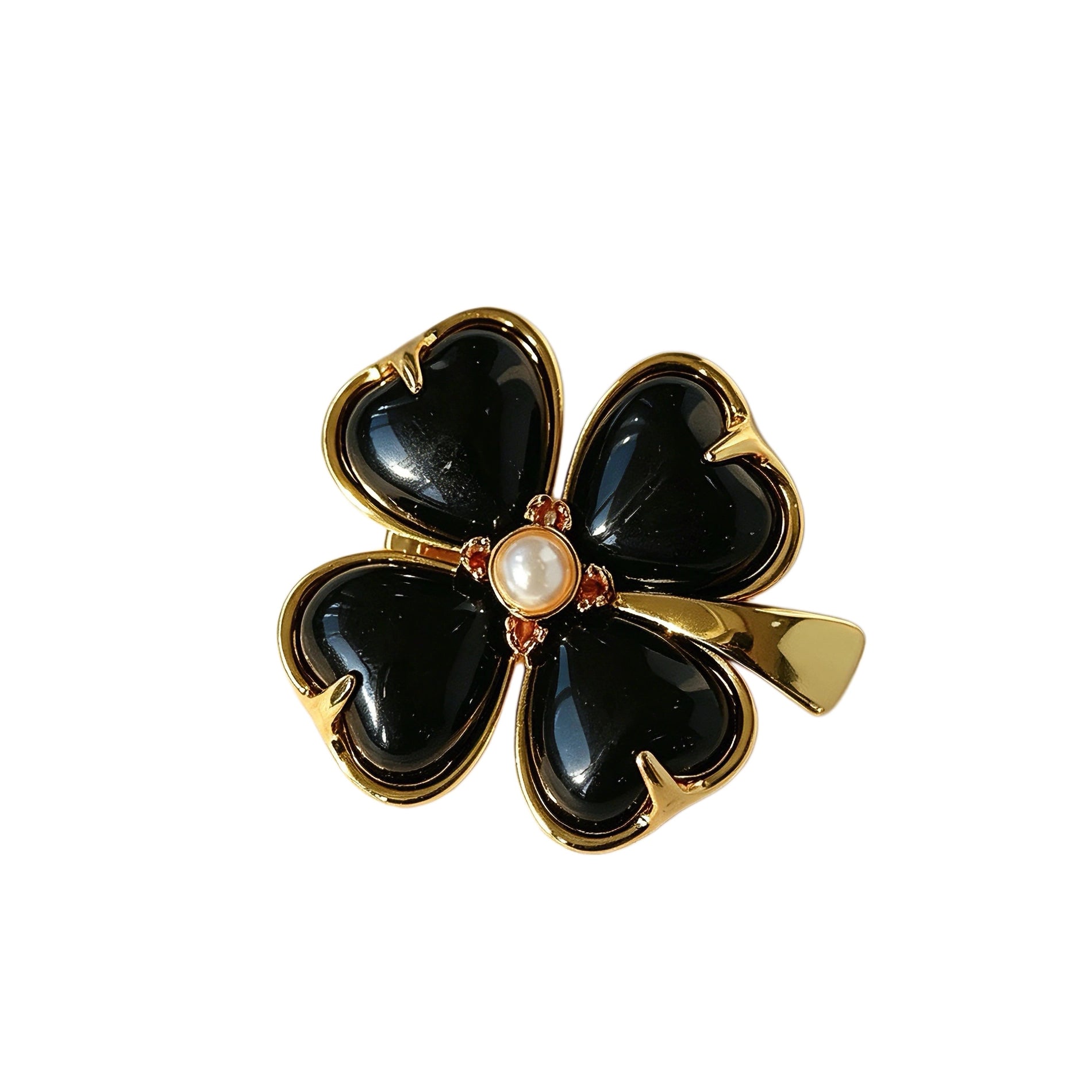 These four-leaf clover brooches come in two elegant versions: one with glossy black onyx petals centered by a delicate pearl, and the other with milky white crystal petals accented by a deep red gemstone at its core. Both are framed in polished gold-toned metal, exuding a classic, vintage-inspired charm.
