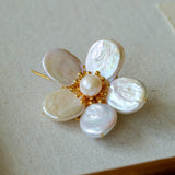Features a stunning 7-7.5mm natural freshwater baroque pearl as the centerpiece, surrounded by artistically sculpted shell petals and vibrant red agate/black onyx accents. This flower brooch blends vintage charm with modern "light luxury" style, making it a captivating focal point for any outfit.