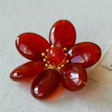 Features a stunning 7-7.5mm natural freshwater baroque pearl as the centerpiece, surrounded by artistically sculpted shell petals and vibrant red agate/black onyx accents. This flower brooch blends vintage charm with modern "light luxury" style, making it a captivating focal point for any outfit.