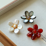 Features a stunning 7-7.5mm natural freshwater baroque pearl as the centerpiece, surrounded by artistically sculpted shell petals and vibrant red agate/black onyx accents. This flower brooch blends vintage charm with modern "light luxury" style, making it a captivating focal point for any outfit.