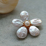 Features a stunning 7-7.5mm natural freshwater baroque pearl as the centerpiece, surrounded by artistically sculpted shell petals and vibrant red agate/black onyx accents. This flower brooch blends vintage charm with modern "light luxury" style, making it a captivating focal point for any outfit.