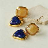 These French vintage-style drop earrings feature a geometric design, crafted with polished gold-tone metal settings. Each earring is adorned with two linked gemstone pendants: a cushion-cut square top and a heart-shaped bottom, made from natural agate in rich, varied hues like warm orange, deep blue, forest green, and vibrant red. The elegant, retro silhouette blends classic charm with a bold, colorful aesthetic, perfect for adding a statement touch to any look.