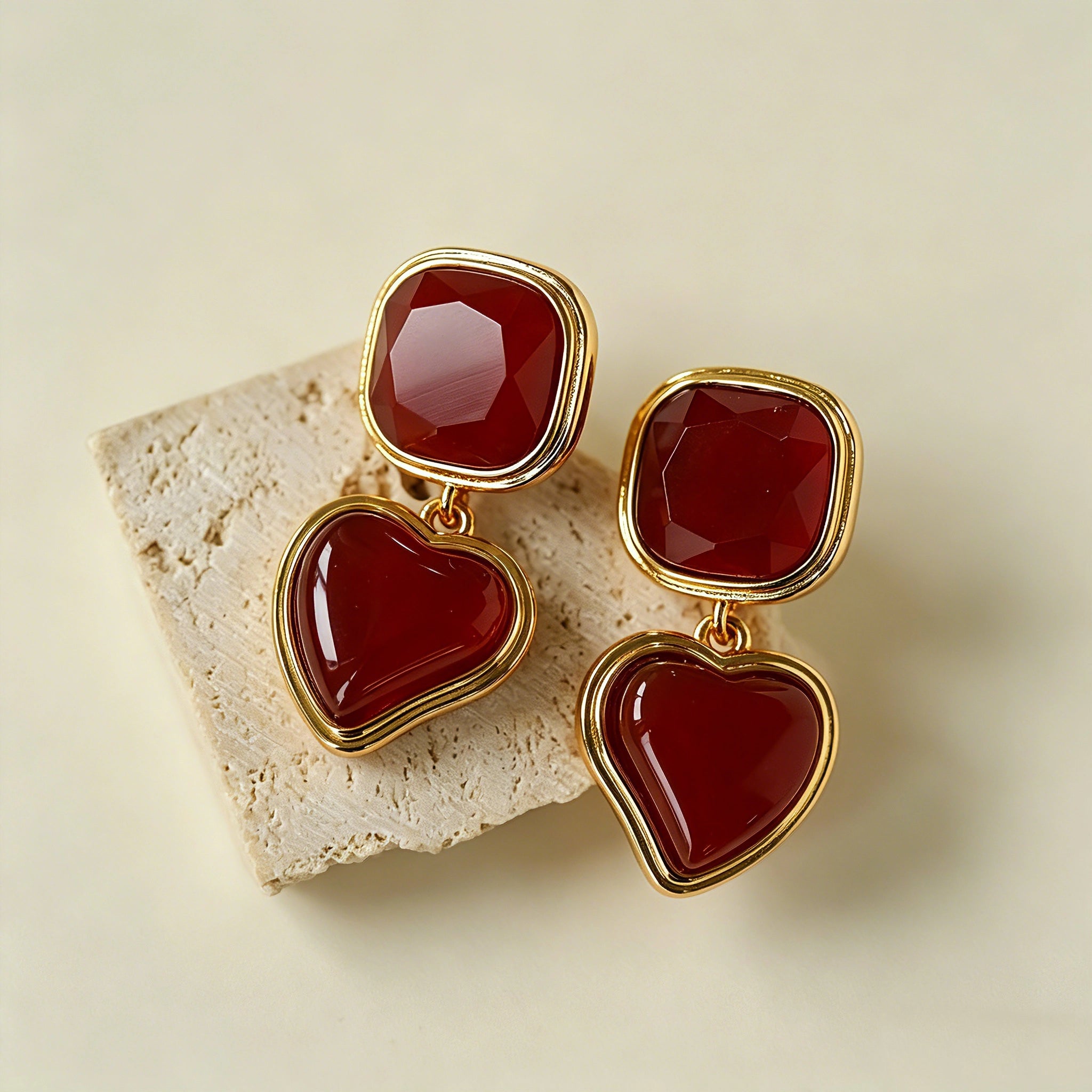 These French vintage-style drop earrings feature a geometric design, crafted with polished gold-tone metal settings. Each earring is adorned with two linked gemstone pendants: a cushion-cut square top and a heart-shaped bottom, made from natural agate in rich, varied hues like warm orange, deep blue, forest green, and vibrant red. The elegant, retro silhouette blends classic charm with a bold, colorful aesthetic, perfect for adding a statement touch to any look.