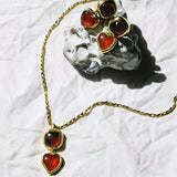 These French vintage-style drop earrings feature a geometric design, crafted with polished gold-tone metal settings. Each earring is adorned with two linked gemstone pendants: a cushion-cut square top and a heart-shaped bottom, made from natural agate in rich, varied hues like warm orange, deep blue, forest green, and vibrant red. The elegant, retro silhouette blends classic charm with a bold, colorful aesthetic, perfect for adding a statement touch to any look.