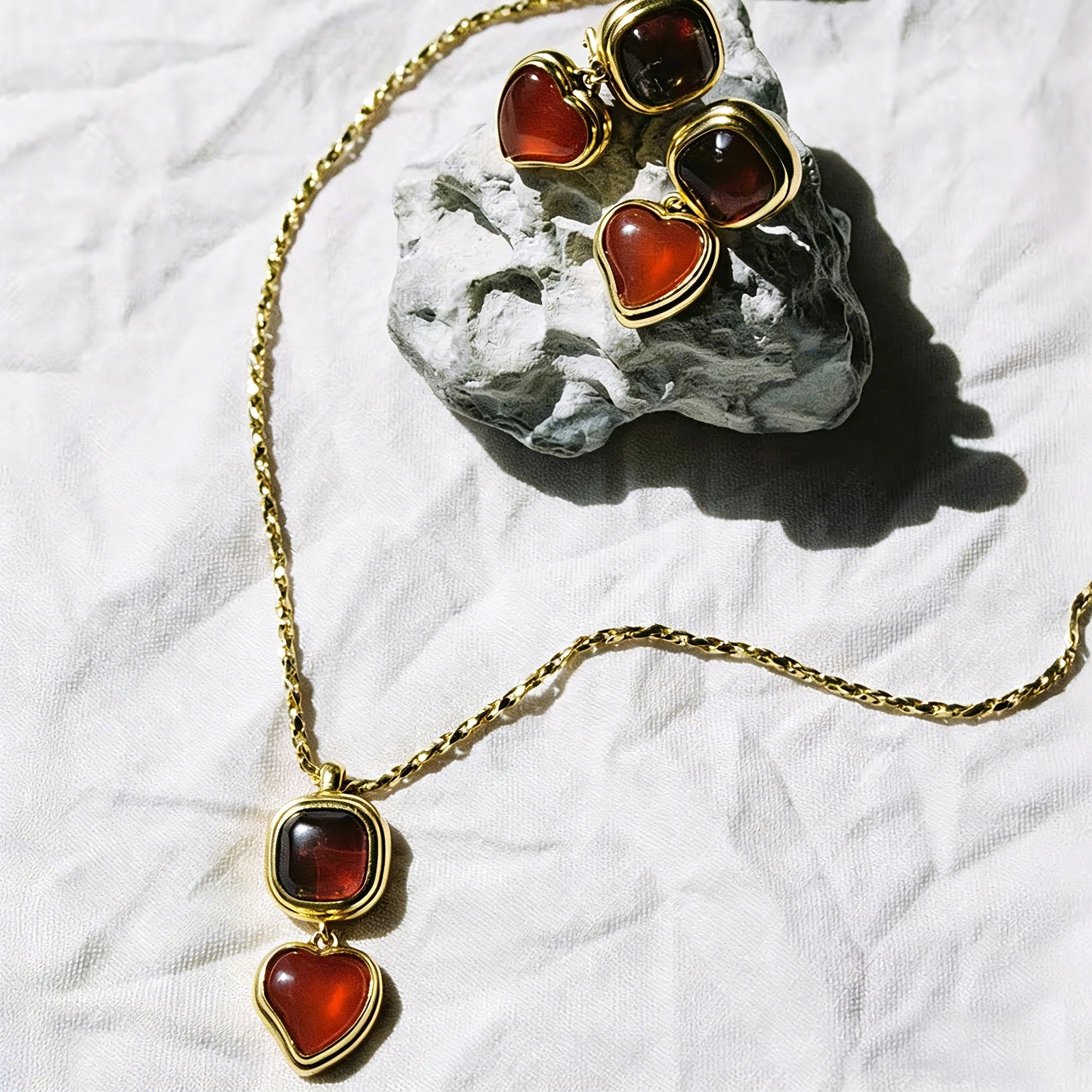 These French vintage-style drop earrings feature a geometric design, crafted with polished gold-tone metal settings. Each earring is adorned with two linked gemstone pendants: a cushion-cut square top and a heart-shaped bottom, made from natural agate in rich, varied hues like warm orange, deep blue, forest green, and vibrant red. The elegant, retro silhouette blends classic charm with a bold, colorful aesthetic, perfect for adding a statement touch to any look.