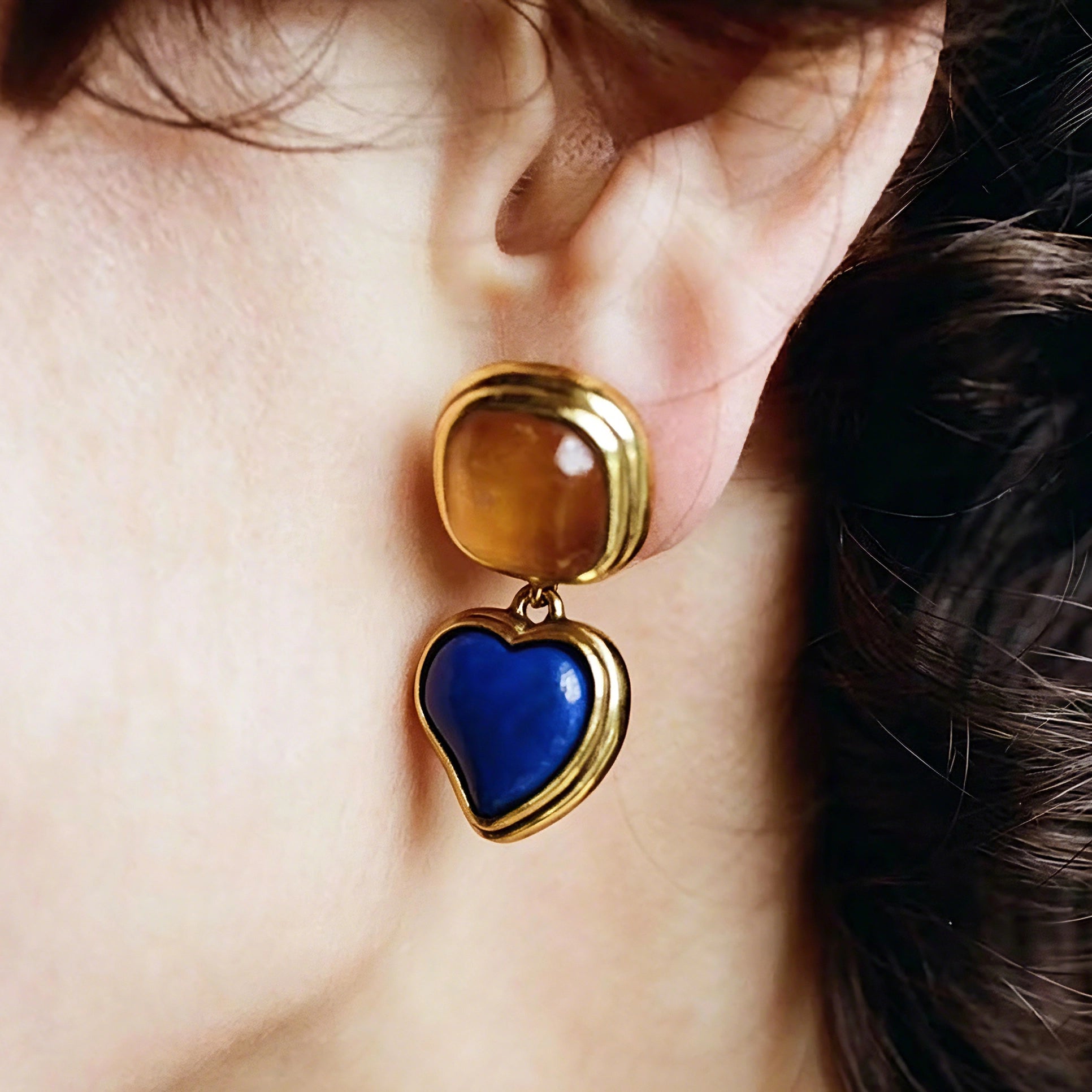 These French vintage-style drop earrings feature a geometric design, crafted with polished gold-tone metal settings. Each earring is adorned with two linked gemstone pendants: a cushion-cut square top and a heart-shaped bottom, made from natural agate in rich, varied hues like warm orange, deep blue, forest green, and vibrant red. The elegant, retro silhouette blends classic charm with a bold, colorful aesthetic, perfect for adding a statement touch to any look.