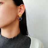 These French vintage-style drop earrings feature a geometric design, crafted with polished gold-tone metal settings. Each earring is adorned with two linked gemstone pendants: a cushion-cut square top and a heart-shaped bottom, made from natural agate in rich, varied hues like warm orange, deep blue, forest green, and vibrant red. The elegant, retro silhouette blends classic charm with a bold, colorful aesthetic, perfect for adding a statement touch to any look.