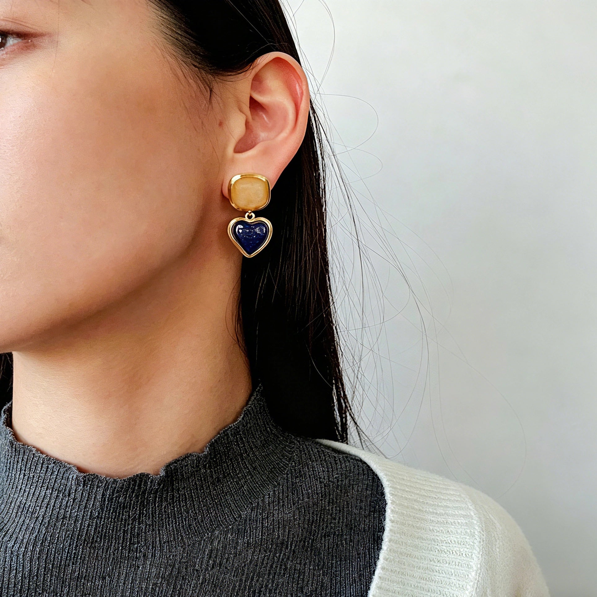 These French vintage-style drop earrings feature a geometric design, crafted with polished gold-tone metal settings. Each earring is adorned with two linked gemstone pendants: a cushion-cut square top and a heart-shaped bottom, made from natural agate in rich, varied hues like warm orange, deep blue, forest green, and vibrant red. The elegant, retro silhouette blends classic charm with a bold, colorful aesthetic, perfect for adding a statement touch to any look.