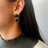 These French vintage-style drop earrings feature a geometric design, crafted with polished gold-tone metal settings. Each earring is adorned with two linked gemstone pendants: a cushion-cut square top and a heart-shaped bottom, made from natural agate in rich, varied hues like warm orange, deep blue, forest green, and vibrant red. The elegant, retro silhouette blends classic charm with a bold, colorful aesthetic, perfect for adding a statement touch to any look.