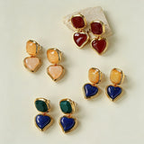 These French vintage-style drop earrings feature a geometric design, crafted with polished gold-tone metal settings. Each earring is adorned with two linked gemstone pendants: a cushion-cut square top and a heart-shaped bottom, made from natural agate in rich, varied hues like warm orange, deep blue, forest green, and vibrant red. The elegant, retro silhouette blends classic charm with a bold, colorful aesthetic, perfect for adding a statement touch to any look.