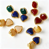 These French vintage-style drop earrings feature a geometric design, crafted with polished gold-tone metal settings. Each earring is adorned with two linked gemstone pendants: a cushion-cut square top and a heart-shaped bottom, made from natural agate in rich, varied hues like warm orange, deep blue, forest green, and vibrant red. The elegant, retro silhouette blends classic charm with a bold, colorful aesthetic, perfect for adding a statement touch to any look.