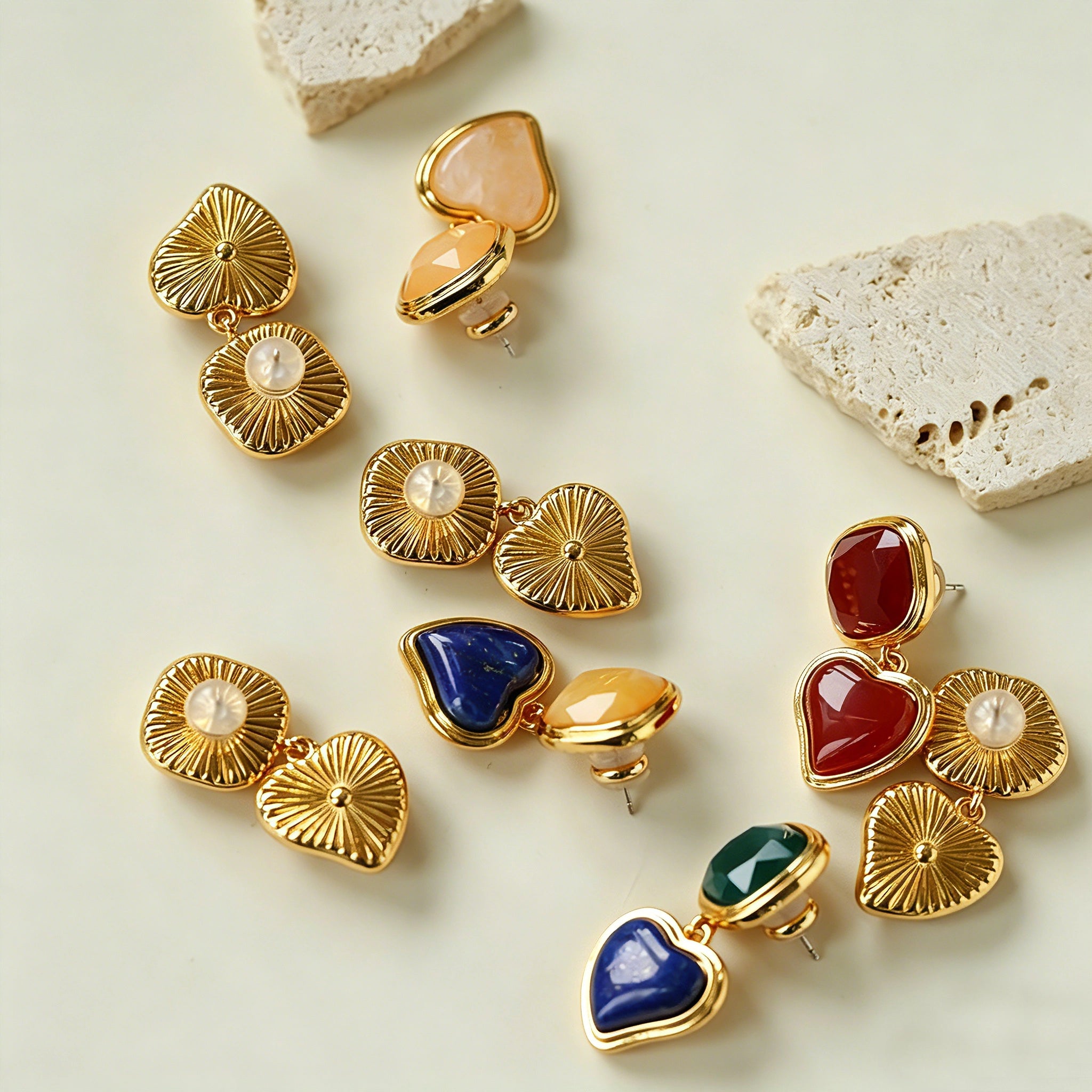 These French vintage-style drop earrings feature a geometric design, crafted with polished gold-tone metal settings. Each earring is adorned with two linked gemstone pendants: a cushion-cut square top and a heart-shaped bottom, made from natural agate in rich, varied hues like warm orange, deep blue, forest green, and vibrant red. The elegant, retro silhouette blends classic charm with a bold, colorful aesthetic, perfect for adding a statement touch to any look.