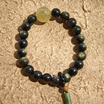 Simple obsidian rounds, radiant rutile, and a sandalwood-agate pendant echo Chinese heritage.