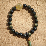 Simple obsidian rounds, radiant rutile, and a sandalwood-agate pendant echo Chinese heritage.