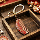 These mini comb keychains are crafted with elegant Chinese Song brocade fabric, showcasing classic traditional patterns in soft green, blush pink, and vintage cream tones. Each delicate hair comb pendant is matched with a glossy pearl lanyard and golden hardware, blending ancient oriental aesthetics with portable daily accessory design. A charming small heritage-style ornament perfect for bags, keys and gifting.