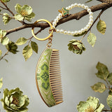  These mini comb keychains are crafted with elegant Chinese Song brocade fabric, showcasing classic traditional patterns in soft green, blush pink, and vintage cream tones. Each delicate hair comb pendant is matched with a glossy pearl lanyard and golden hardware, blending ancient oriental aesthetics with portable daily accessory design. A charming small heritage-style ornament perfect for bags, keys and gifting.