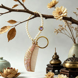  These mini comb keychains are crafted with elegant Chinese Song brocade fabric, showcasing classic traditional patterns in soft green, blush pink, and vintage cream tones. Each delicate hair comb pendant is matched with a glossy pearl lanyard and golden hardware, blending ancient oriental aesthetics with portable daily accessory design. A charming small heritage-style ornament perfect for bags, keys and gifting.