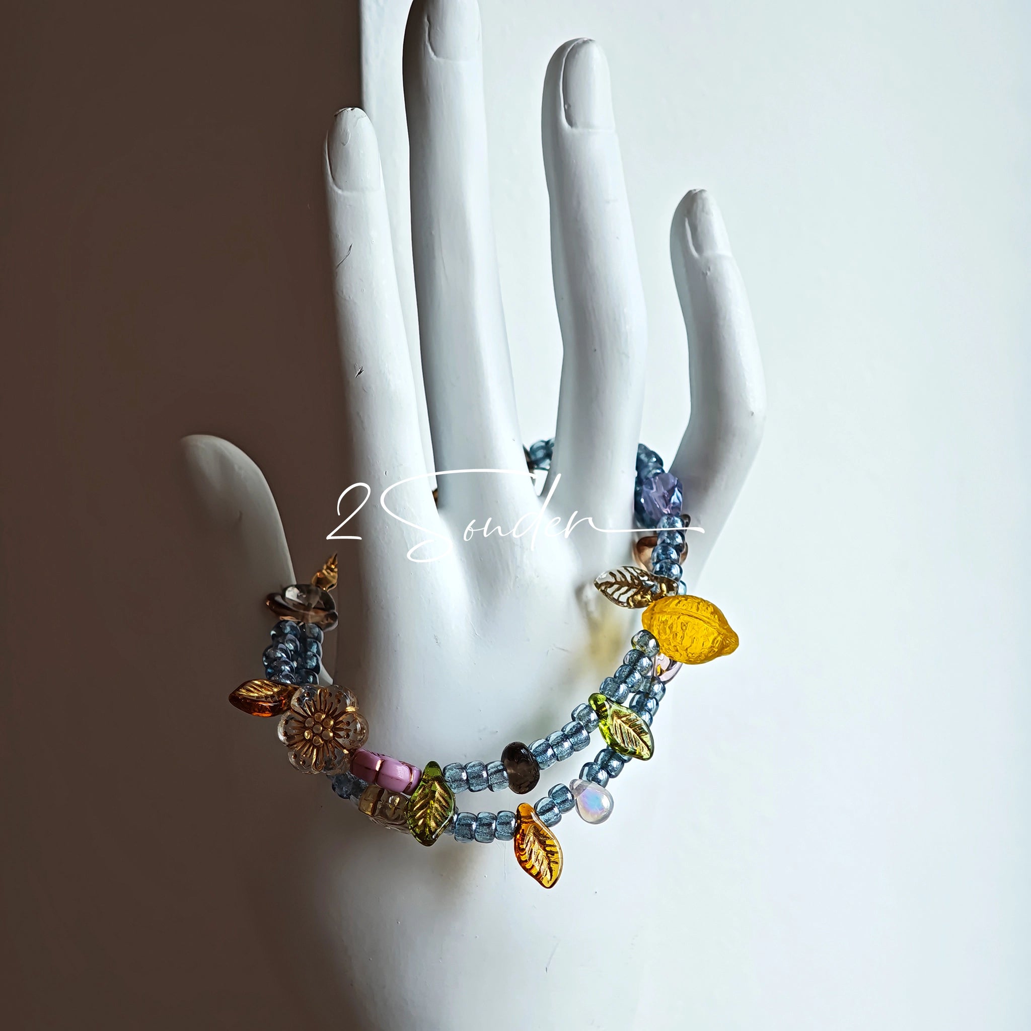 This bracelet features shimmering Czech glass beads in beautiful shades of blue, all hand-strung on a delicate double chain. An 18k gold-plated magnetic clasp makes it super easy to wear, and it's designed for a 15cm wrist.
