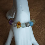 Gentle aquamarine embraces amethyst nobility beside citrine warmth, prehnite softness, and phantom mystery.