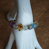 Gentle aquamarine embraces amethyst nobility beside citrine warmth, prehnite softness, and phantom mystery.