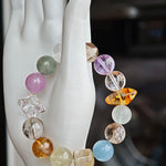 A quiet symphony of aquamarine, amethyst, citrine, prehnite, and phantom quartz plays on your wrist.
