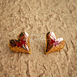 This is a pair of heart earrings with puzzle blocks pattern on the surface. The earrings feature a vibrant enamel center that mimics a beating heart flowing with love. The material of the earrings is sterling silver and enamel, and the color is vintage gold color