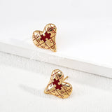This is a pair of heart earrings with puzzle blocks pattern on the surface. The earrings feature a vibrant enamel center that mimics a beating heart flowing with love. The material of the earrings is sterling silver and enamel, and the color is vintage gold color