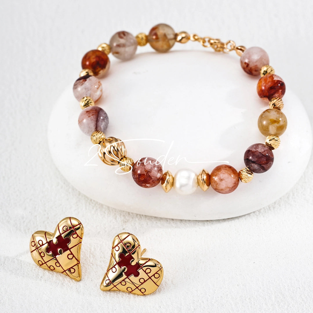 This is a pair of heart earrings with puzzle blocks pattern on the surface. The earrings feature a vibrant enamel center that mimics a beating heart flowing with love. The material of the earrings is sterling silver and enamel, and the color is vintage gold color