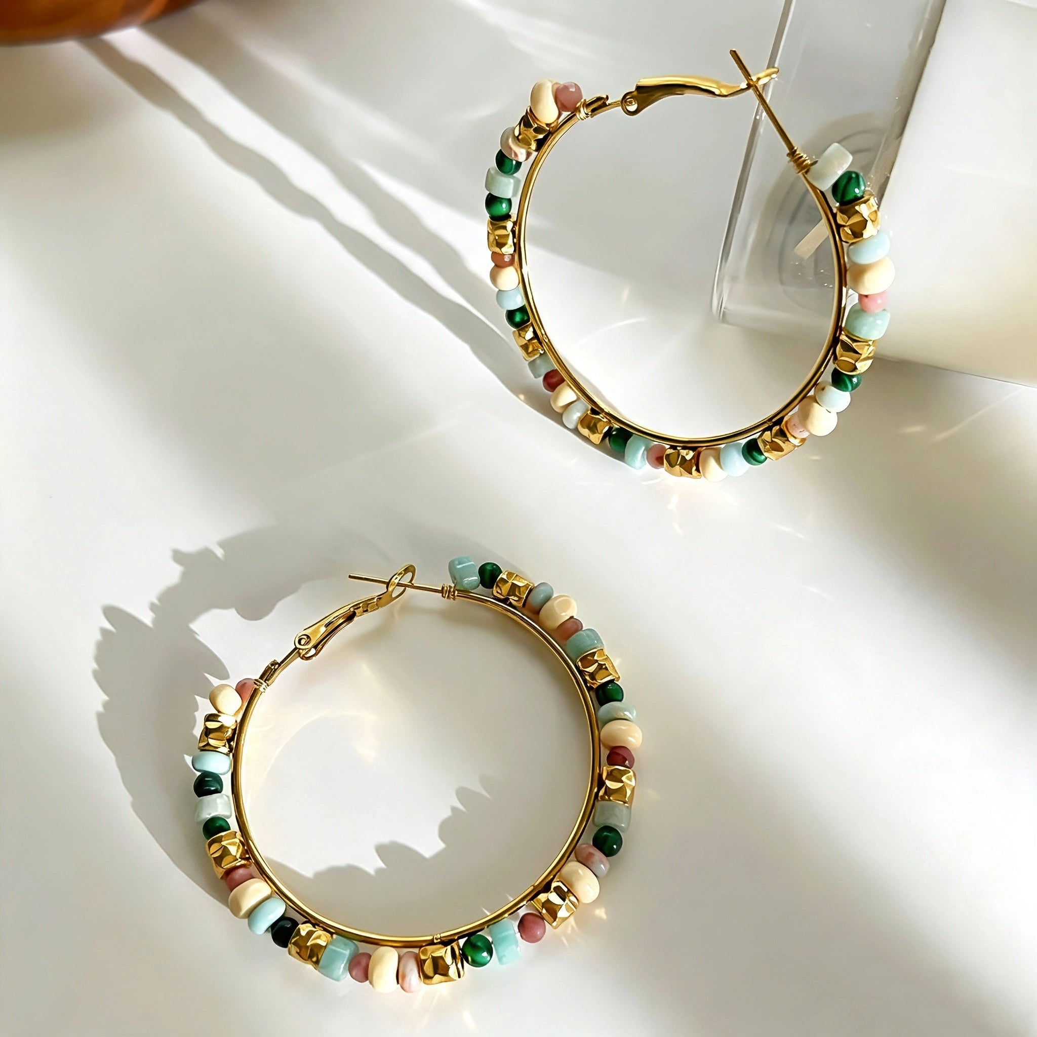 These women’s hoop earrings are crafted from durable stainless‑steel hoops decorated with vibrant natural stone beads. The colorful mixed‑stone design brings a fresh bohemian vibe, adding lively visual charm to your outfits. They are lightweight and ideal for daily wear as well as casual‑party styling.