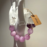 This is a multi gemstones bracelet consists of Kunzite, White Phantom Quartzs and Raw Amethysts. The beads are between 14.5 and 15.5mm. And in the bracelets, there are  hypoallergenic silver spacers and floral accents.