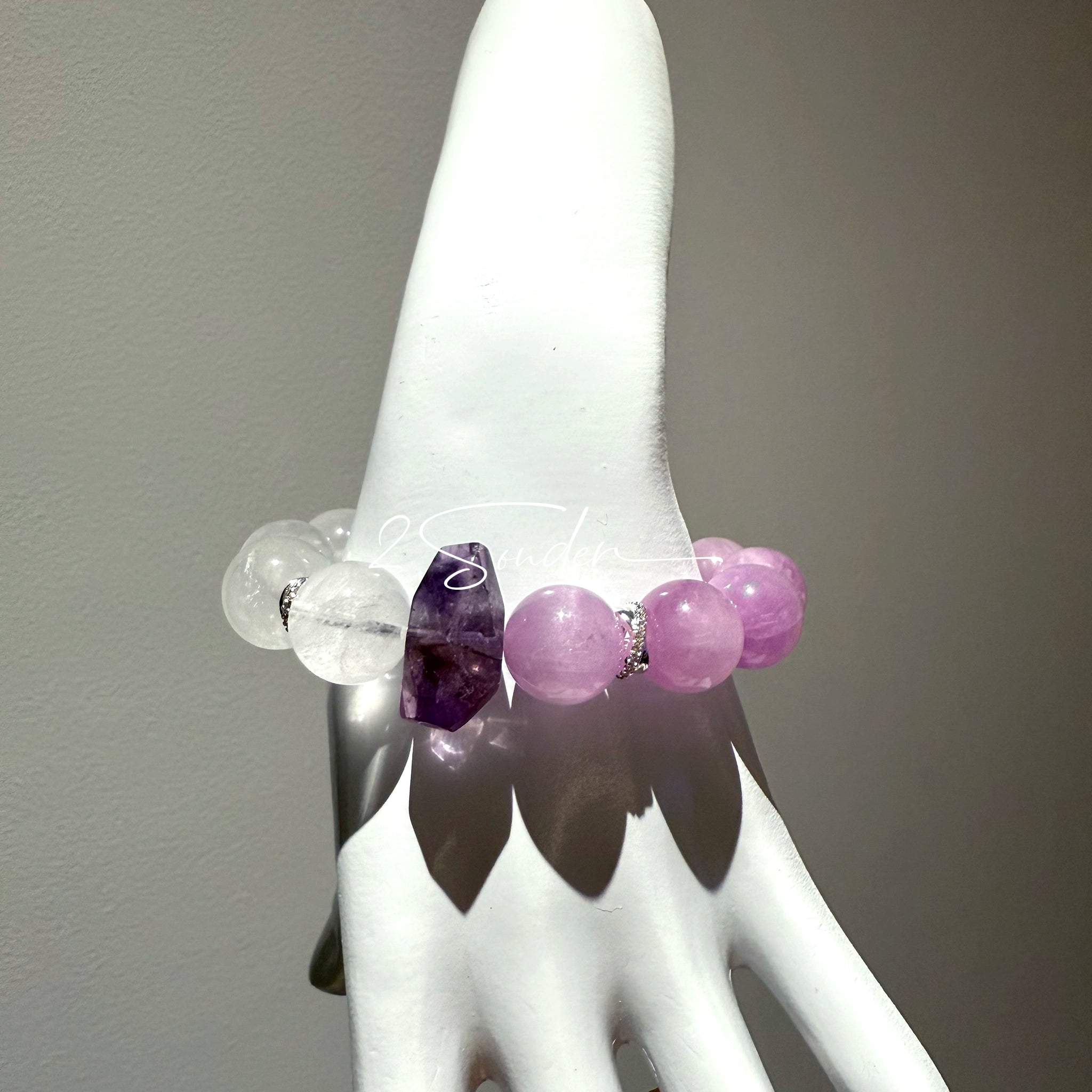 This is a multi gemstones bracelet consists of Kunzite, White Phantom Quartzs and Raw Amethysts. The beads are between 14.5 and 15.5mm. And in the bracelets, there are  hypoallergenic silver spacers and floral accents.
