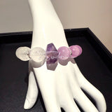 This is a multi gemstones bracelet consists of Kunzite, White Phantom Quartzs and Raw Amethysts. The beads are between 14.5 and 15.5mm. And in the bracelets, there are  hypoallergenic silver spacers and floral accents.