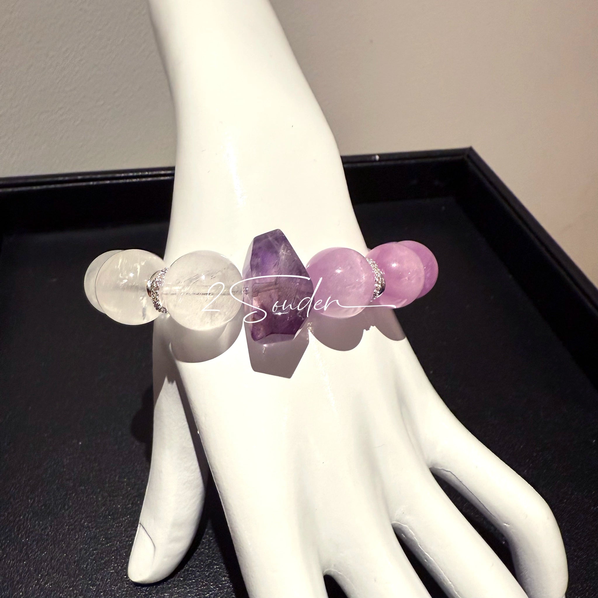 This is a multi gemstones bracelet consists of Kunzite, White Phantom Quartzs and Raw Amethysts. The beads are between 14.5 and 15.5mm. And in the bracelets, there are  hypoallergenic silver spacers and floral accents.