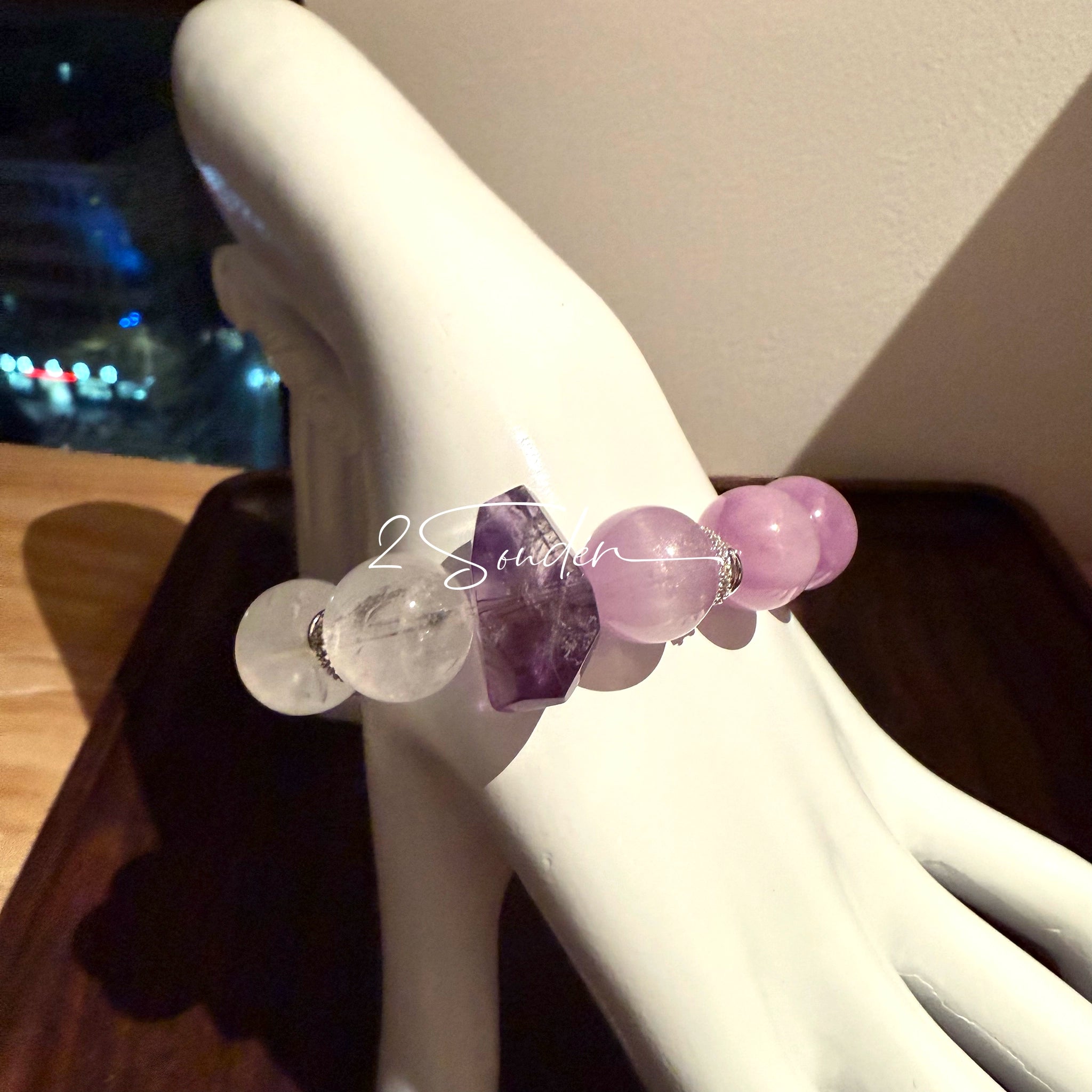 This is a multi gemstones bracelet consists of Kunzite, White Phantom Quartzs and Raw Amethysts. The beads are between 14.5 and 15.5mm. And in the bracelets, there are  hypoallergenic silver spacers and floral accents.