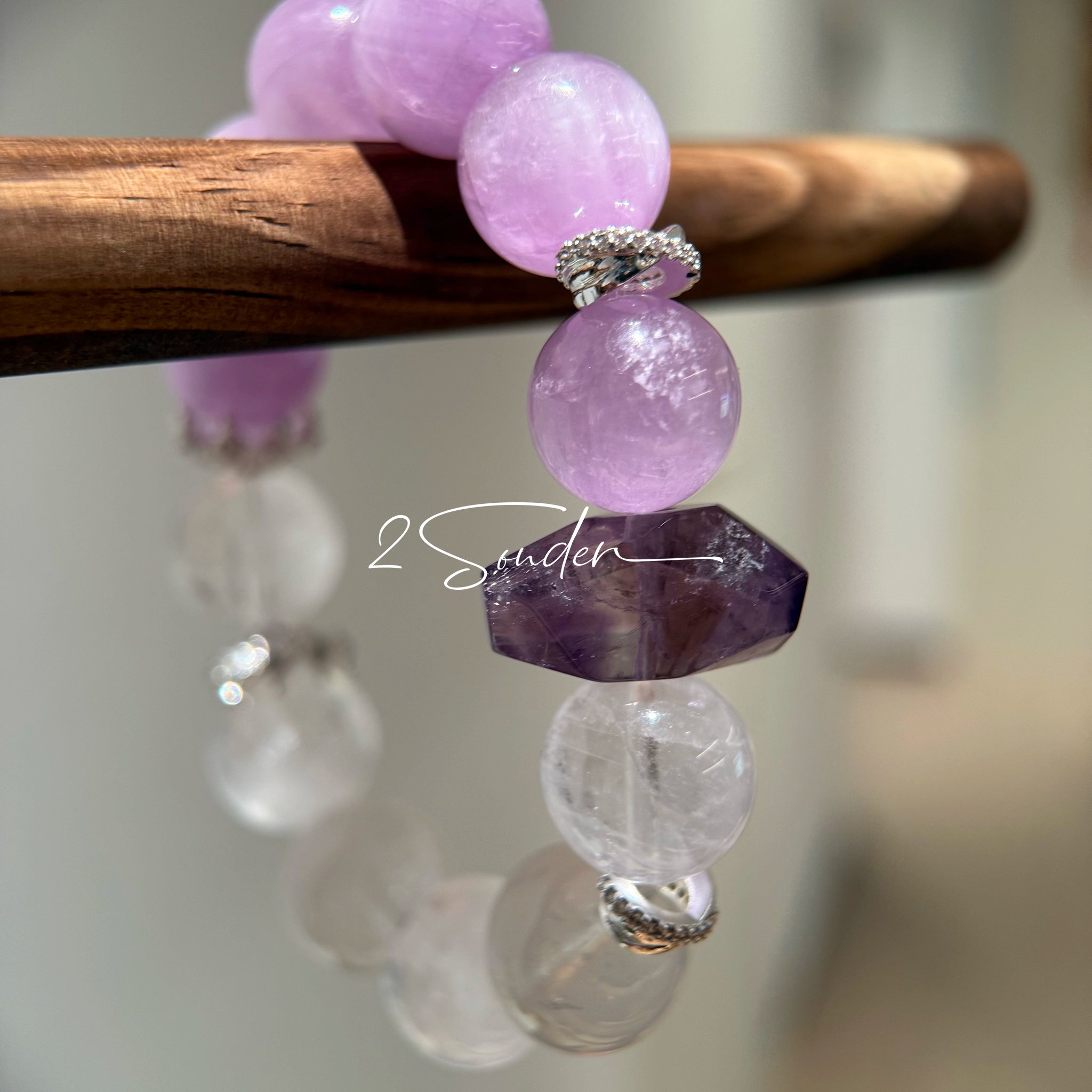 This is a multi gemstones bracelet consists of Kunzite, White Phantom Quartzs and Raw Amethysts. The beads are between 14.5 and 15.5mm. And in the bracelets, there are  hypoallergenic silver spacers and floral accents.