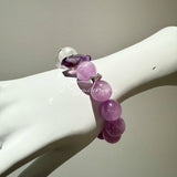 This is a multi gemstones bracelet consists of Kunzite, White Phantom Quartzs and Raw Amethysts. The beads are between 14.5 and 15.5mm. And in the bracelets, there are  hypoallergenic silver spacers and floral accents.