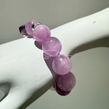 This is a multi gemstones bracelet consists of Kunzite, White Phantom Quartzs and Raw Amethysts. The beads are between 14.5 and 15.5mm. And in the bracelets, there are  hypoallergenic silver spacers and floral accents.