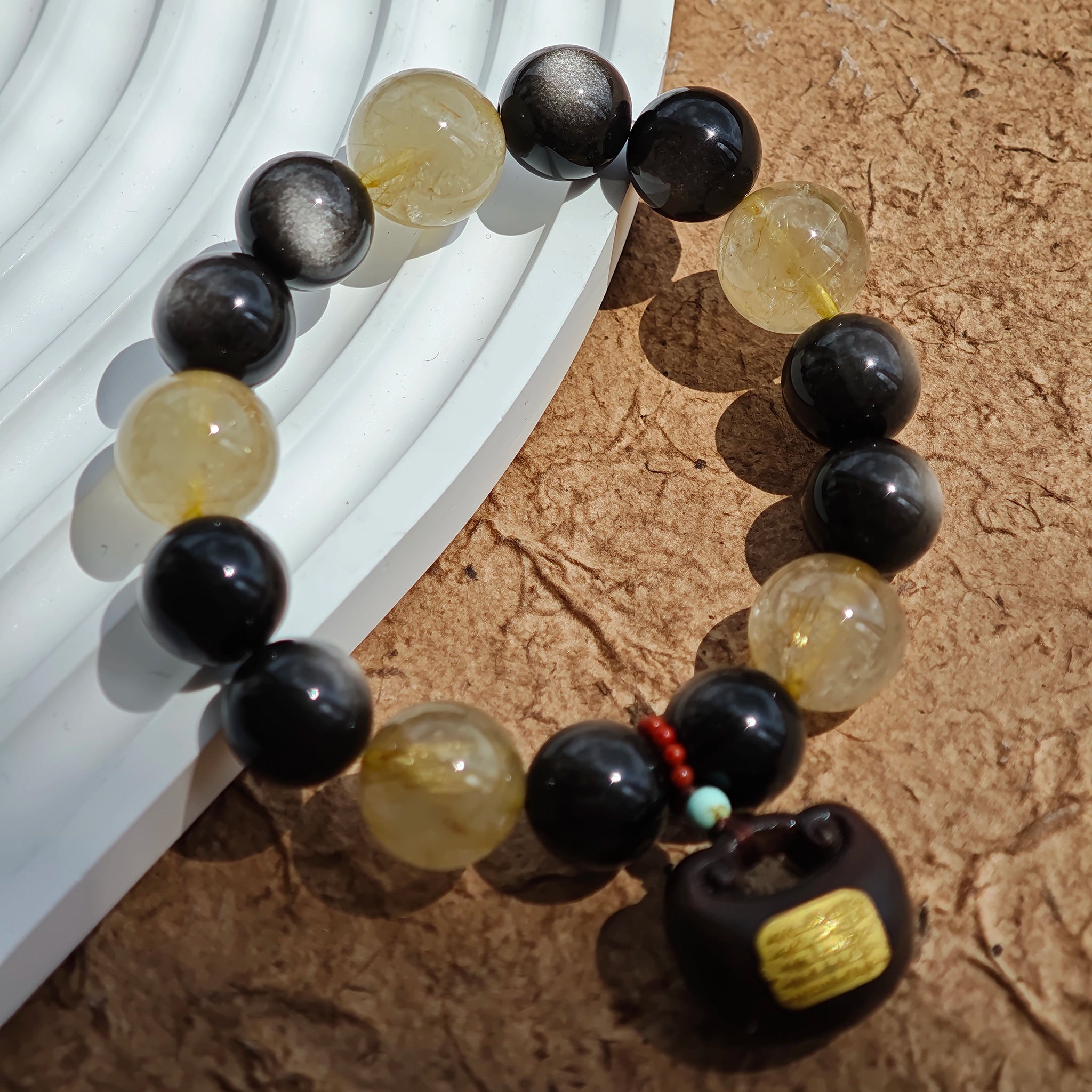 Wear the storm of silver obsidian and the sunrise of golden rutile, laced with agarwood soul and Nanhong heart.