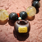 Volcanic gloss meets solar sparkle; sacred wood meets imperial stone—a bracelet that roars quiet wealth.
