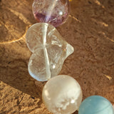 This crystal stack layers aquamarine, rose quartz, clear quartz, citrine, and amethyst like sugary macarons.
