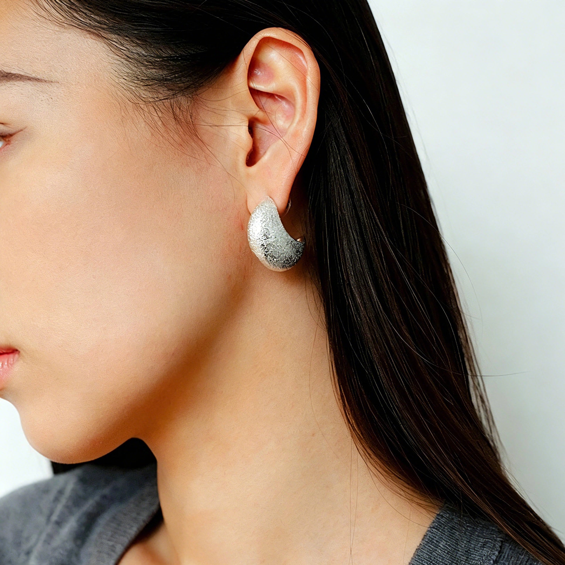 These minimalist high-end stud earrings feature a plump crescent C-shaped design with delicate frosted texture on the whole surface. They are available in two classic colors: elegant gold and versatile silver. With smooth curved lines, the earrings bring understated luxury and fashionable daily wear sense.