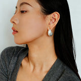These minimalist high-end stud earrings feature a plump crescent C-shaped design with delicate frosted texture on the whole surface. They are available in two classic colors: elegant gold and versatile silver. With smooth curved lines, the earrings bring understated luxury and fashionable daily wear sense.
