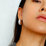 These minimalist high-end stud earrings feature a plump crescent C-shaped design with delicate frosted texture on the whole surface. They are available in two classic colors: elegant gold and versatile silver. With smooth curved lines, the earrings bring understated luxury and fashionable daily wear sense.